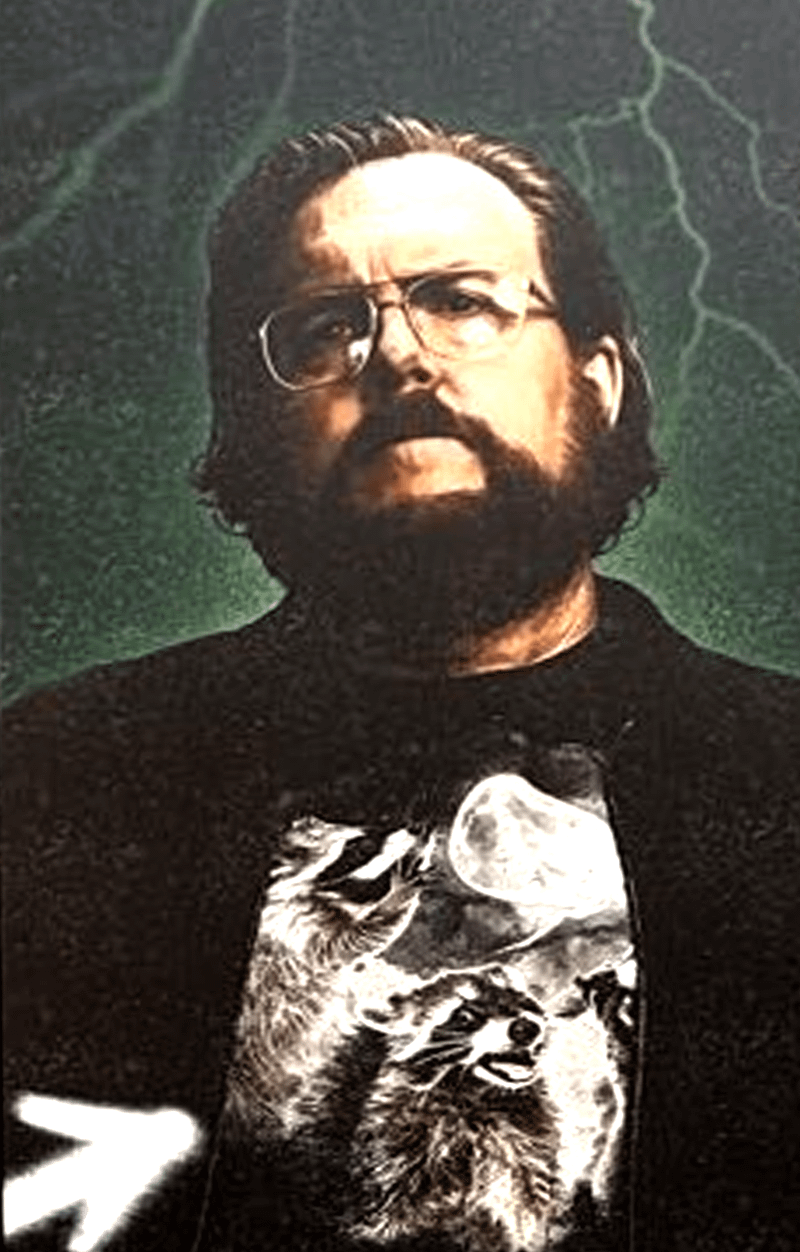 Steve Agee  in black jacket and raccoon t-shirt in Peacemaker Season 2 San Diego Comic-Con poster