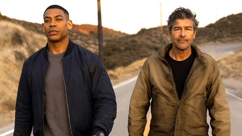 Aaron Pierre as John Stewart and Kyle Chandler as Hal Jordan walking down a road in Lanterns