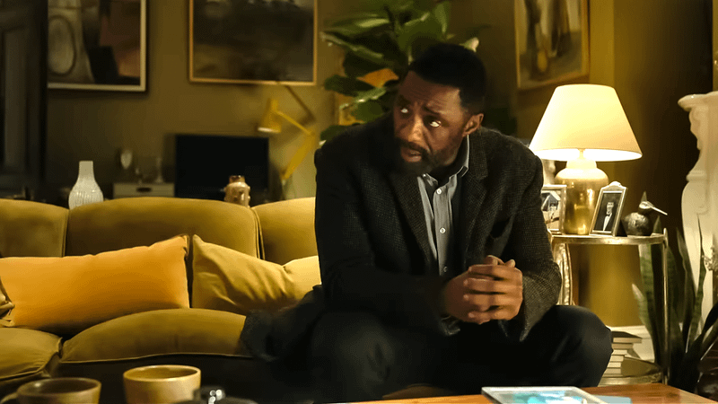 Idris Elba sat on a sofa in Luther