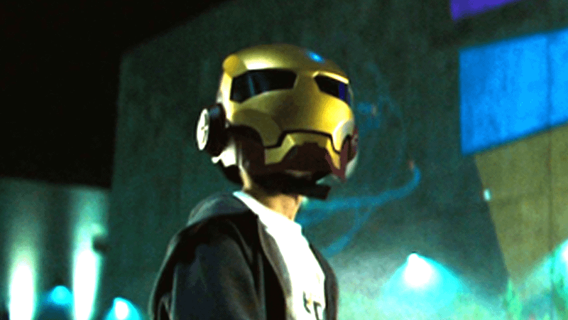 Peter Parker wearing an Iron Man helmet in Iron Man 2.