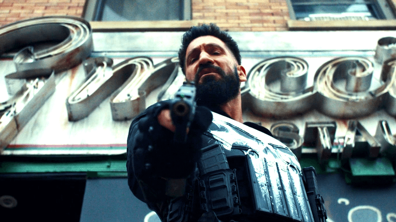 Jon Bernthal's Punisher wields a gun ready to shoot.