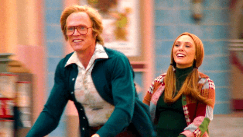 Vision and Wanda Maximoff riding a bike in WandaVision.