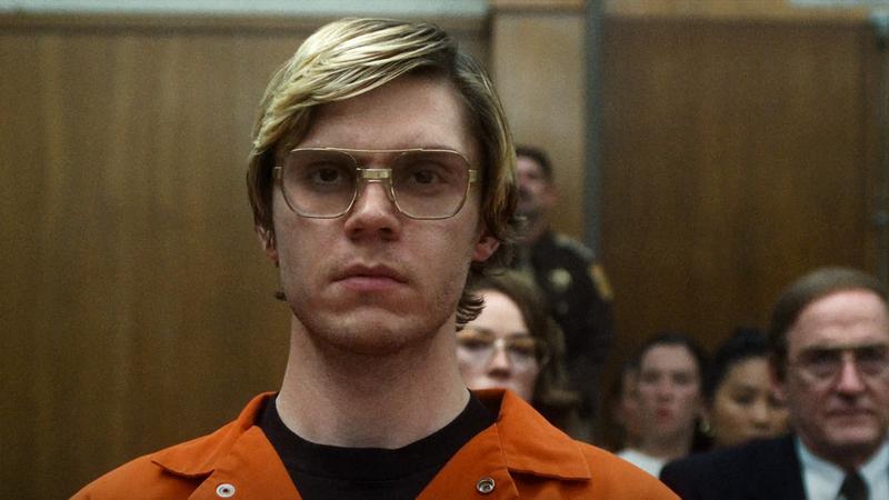 Evan Peters as Jeffrey Dahmer sitting in a court room in Monster: The Jeffrey Dahmer Story