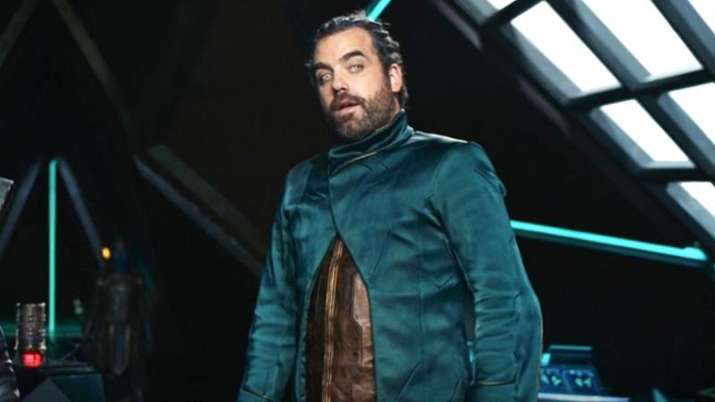 Daniel Ings as Ty-Rone in a blue jacket in The Marvels