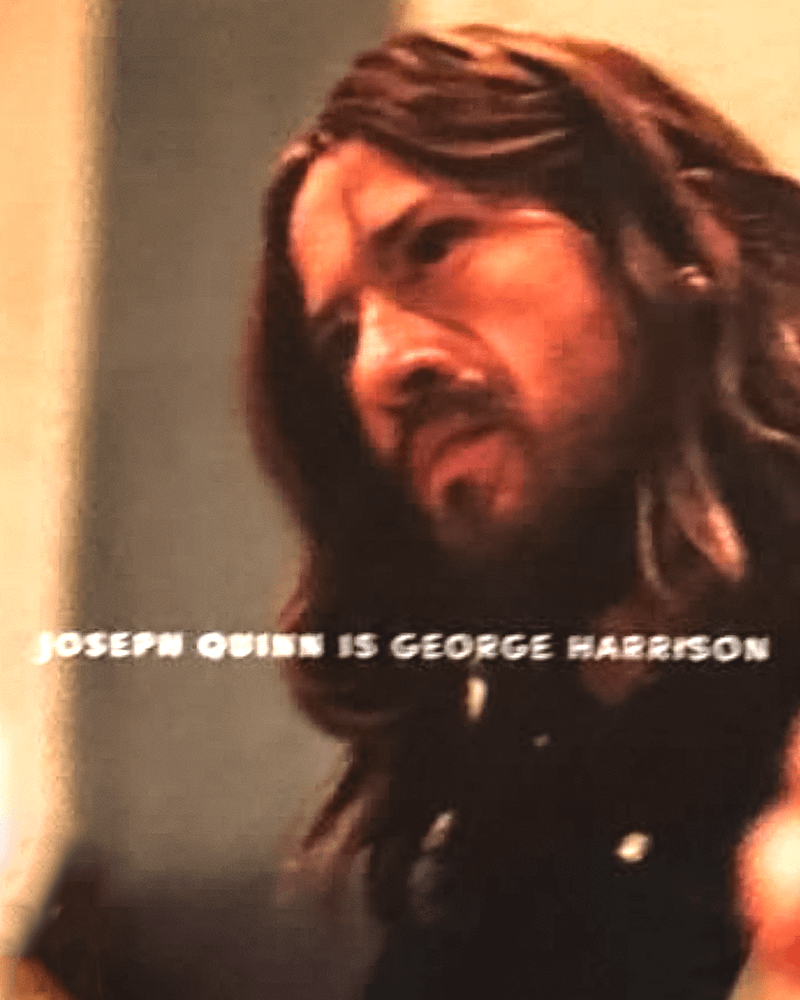 Joseph Quinn as George Harrison with a guitar in his hand in The Beatles movie.