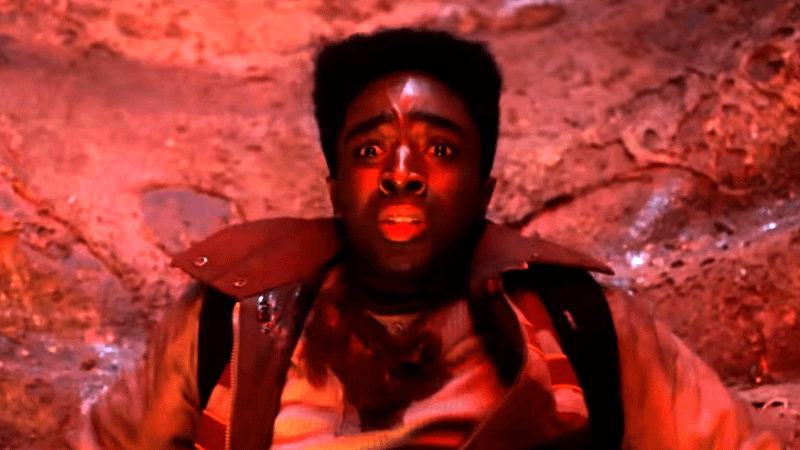 Caleb McLaughlin as Lucas looking terrified at something in front of him in Stranger Things