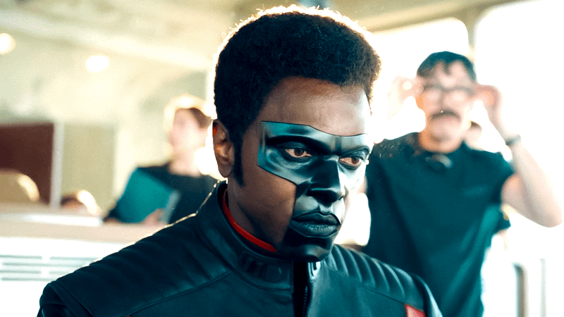 Edi Gathegi as Mister Terrific sitting in a office building in Superman