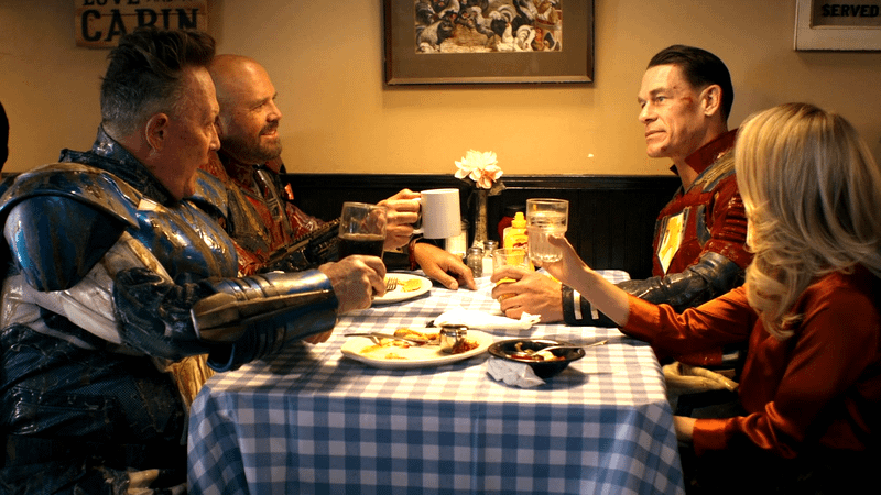 Robert Patrick as Auggie Smith, David Denman as Keith Smith, John Cena as Peacemaker, Jennifer Holland as Emilia Harcourt in 'Peacemaker' Season 2.