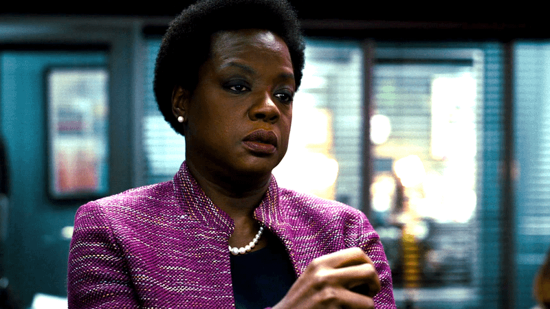 Viola Davis as Amanda Waller in a purple coat looking angry in Waller