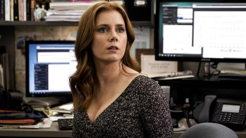 Amy Adams as Lois Lane looking up from her desk in Man of Steel
