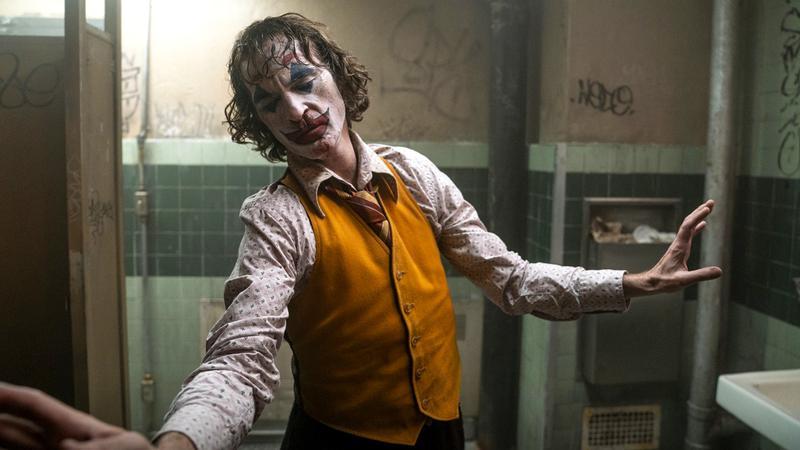 Joaquin Phoenix as Arthur Fleck dancing in a bathroom in Joker