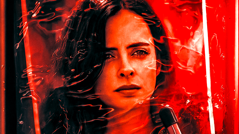 A photo of Krysten Ritter as Jessica Jones sitting in a dark room in development solution in Jessica Jones