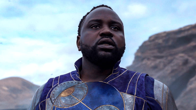 Phastos in Eternals in suit.