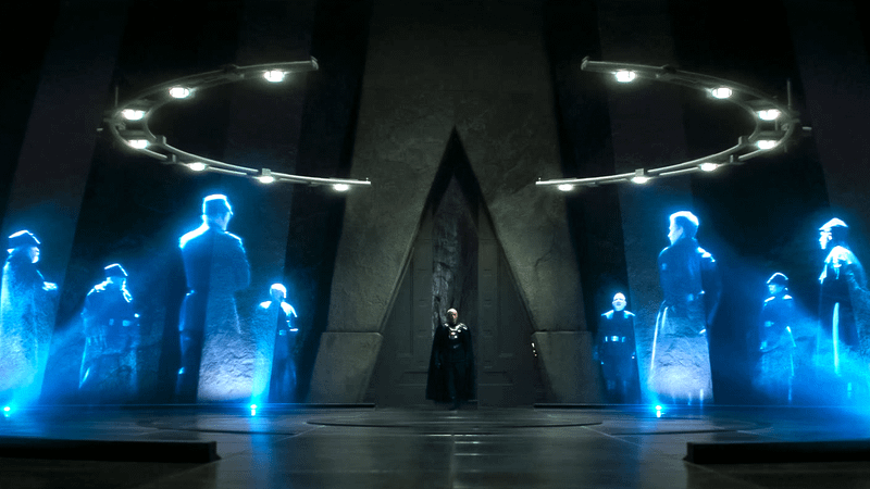 Giancarlo Esposito as Moff Gideon standing in front of several holograms in The Mandalorian