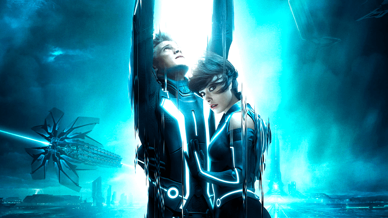 Garret Hedlund as Sam and Olivia Wilde as Quorra holding each other with a beam of light over their head in Tron: Legacy