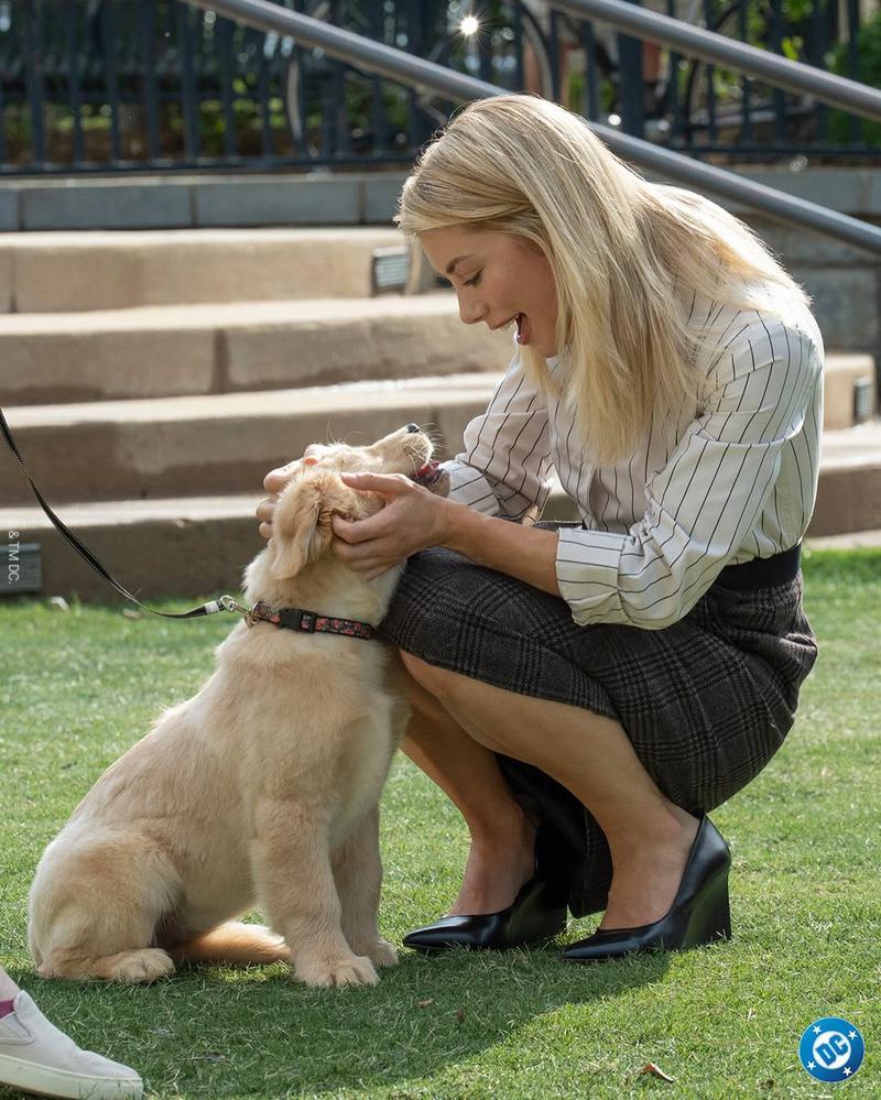 Jennifer Holland and a dog on the set of Peacemaker