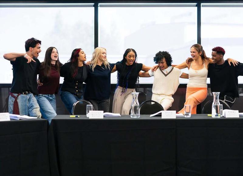 Disney Zombies 5's cast with their arms around each other.