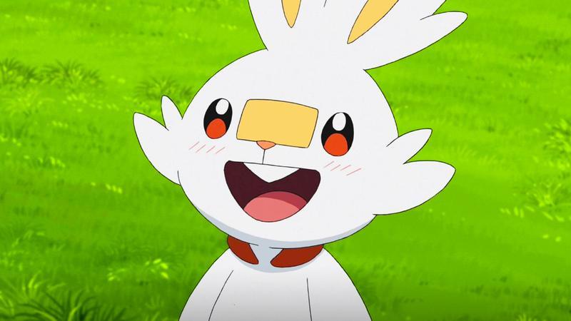 Scorbunny smiling in a field in Pokemon