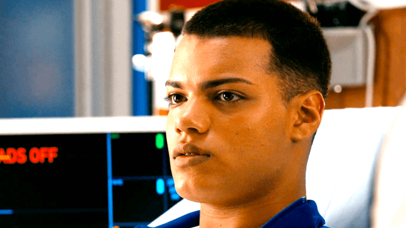 Kevin Chacon looking forward and at a diagonal, in what appears to be a hospital room.