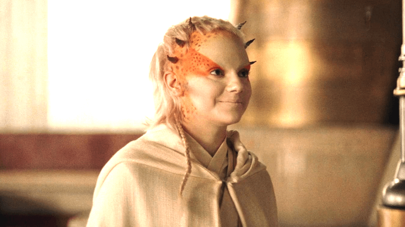 Dafne Keen as Jecki Lon smiling in a white robe in The Acolyte