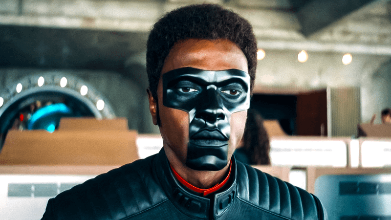 Edi Gathegi as Mr. Terrific standing in a office building in Superman