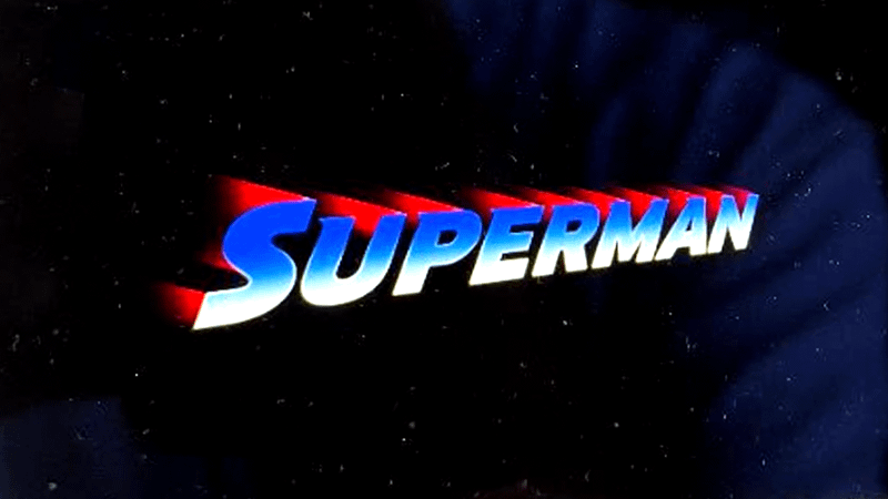 A blue and white Superman logo with red streak behind it