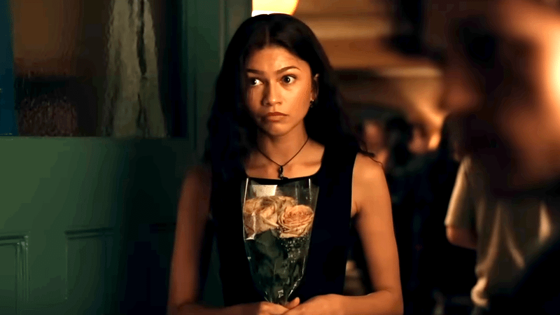 MJ holding a set of flowers Peter gave her.