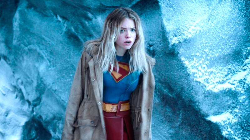 Milly Alcock as Supergirl in a brown coat and her costume in Supergirl