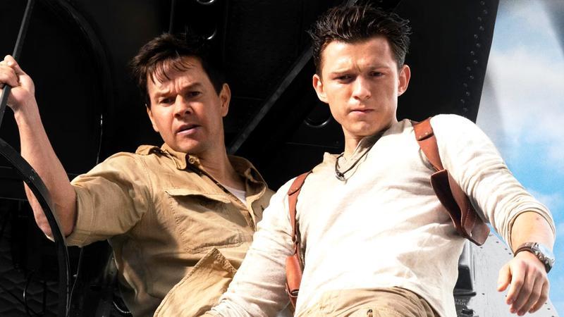 Mark Wahlberg as Sully and Tom Holland as Nathan Drake looking out from a plane in Uncharted