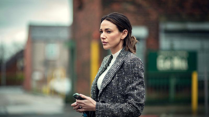 Michelle Keegan as Maya Stern holding a phone in Fool Me Once