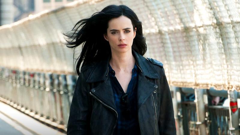 Krysten Ritter as Jessica Jones walking down a city street in Jessica Jones.