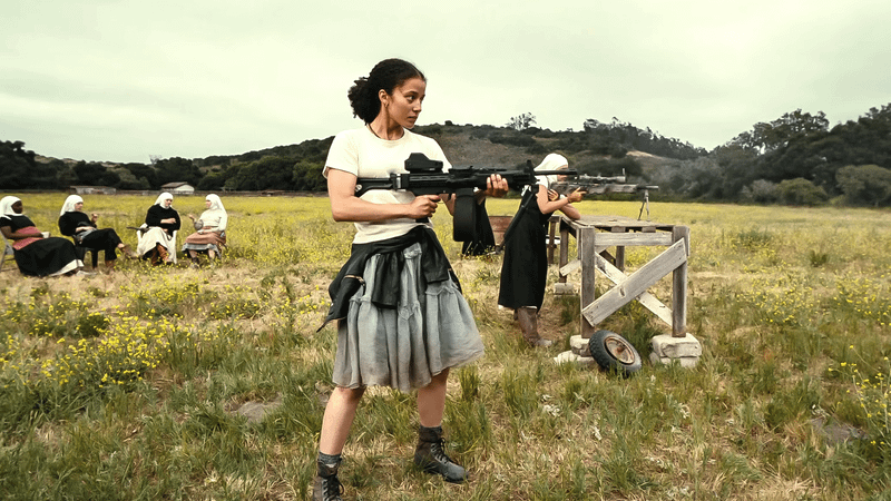 Willa Ferguson wielding an assault rifle in training.