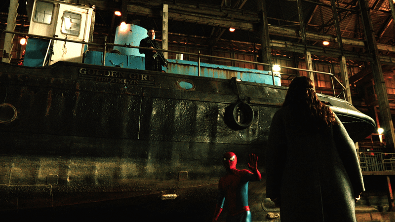 Punisher on top of a docked boat talking down to Spider-Man and MJ.