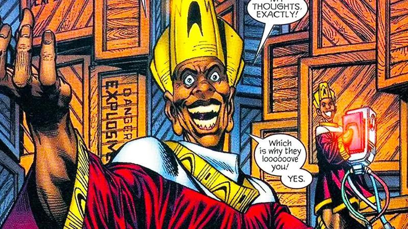 Achebe wears a gold headdress and red, white, and gold robes in Marvel's Black Panther comics.