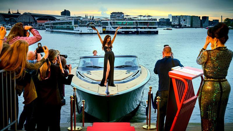 Famke Janssen's Betty posting on a boat in Amsterdam Empire.