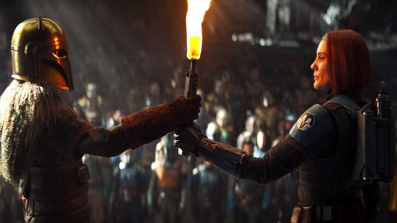 Bo Katan and The Armorer holding a torch in The Mandalorian