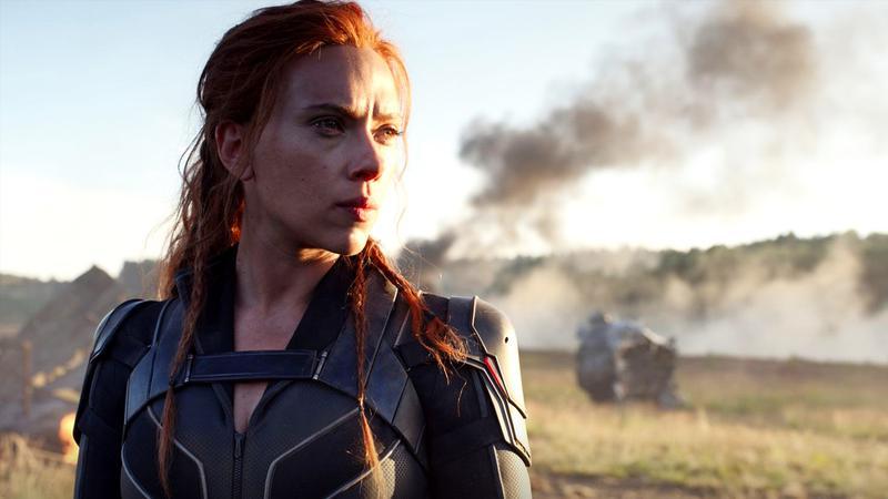Scarlett Johansson as Black Widow standing in front of some smoking wreckage in Black Widow