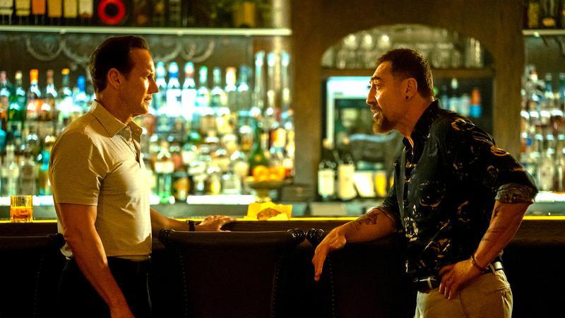 Tom and Max talking at a bar in Cape Fear.