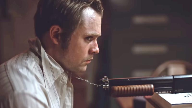 Dacre Montgomery strapped to a gun in Dead Man's Wire