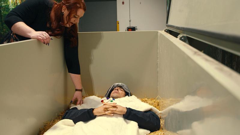 Eli Roth lying in a coffin.