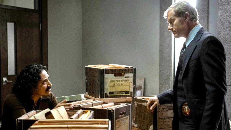 Devil In Disguise star Gabriel Luna in character sitting at a desk.
