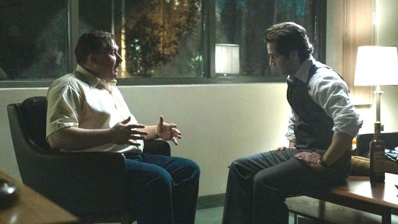 Michael Chernus (John Wayne Gacy) speaking with another man in Devil in Disguise: John Wayne Gacy.