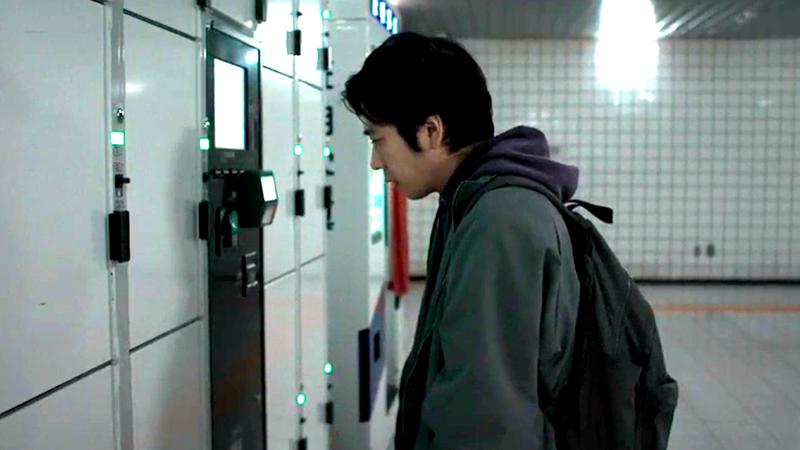 The hero looking at all the haunted lockers in Exit 8.