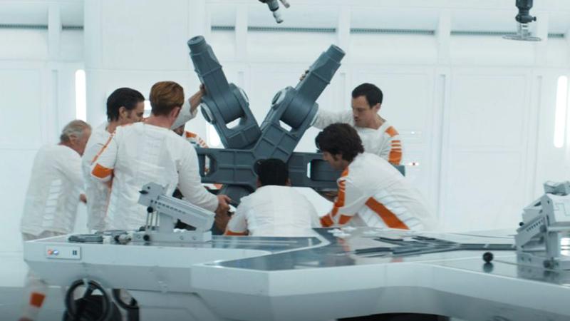 Cassian Andor and his inmates on Narkina 5 lifting a massive mechanical piece in Andor