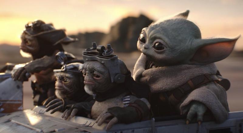 Grogu and three Anzellan in his pram speeding across a desert planet in The Mandalorian & Grogu