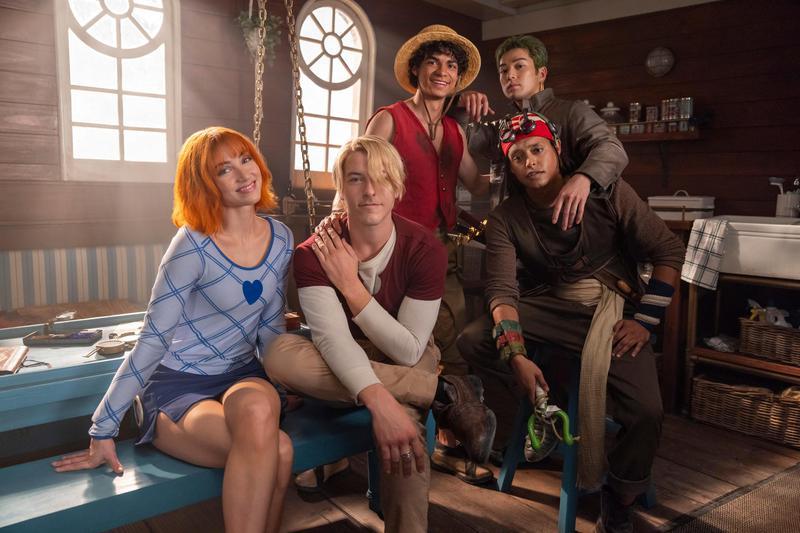 The cast of One Piece sitting in a ship cabin together