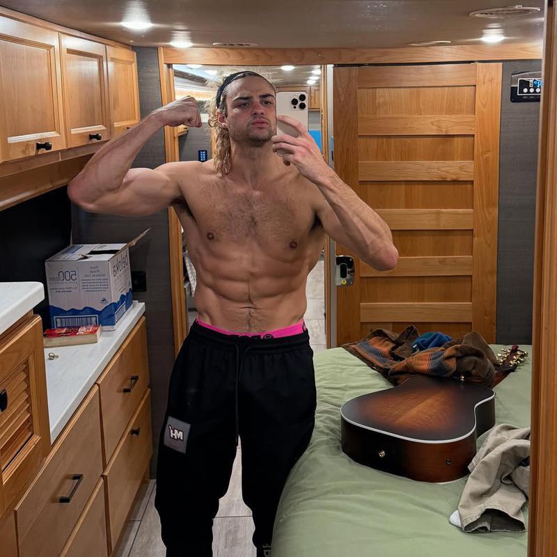 Noah Centineo posing in the mirror on the set of Street Fighter