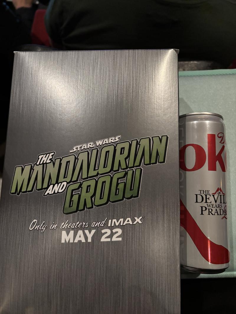 The Mandalorian and Grogu popcorn box, Diet Coke can with The Devil Wears Prada 2 title card on it.