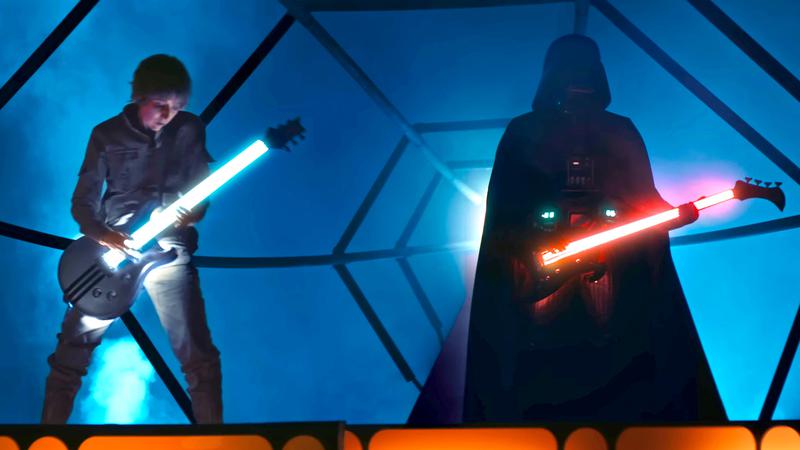 Luke and Darth Vader using lightsaber guitars.