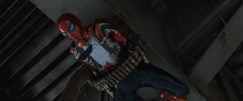 Peter Parker in Spider-Man: No Way Home with part of his Iron Spider Armor ripped off, revealing his clothes underneath.